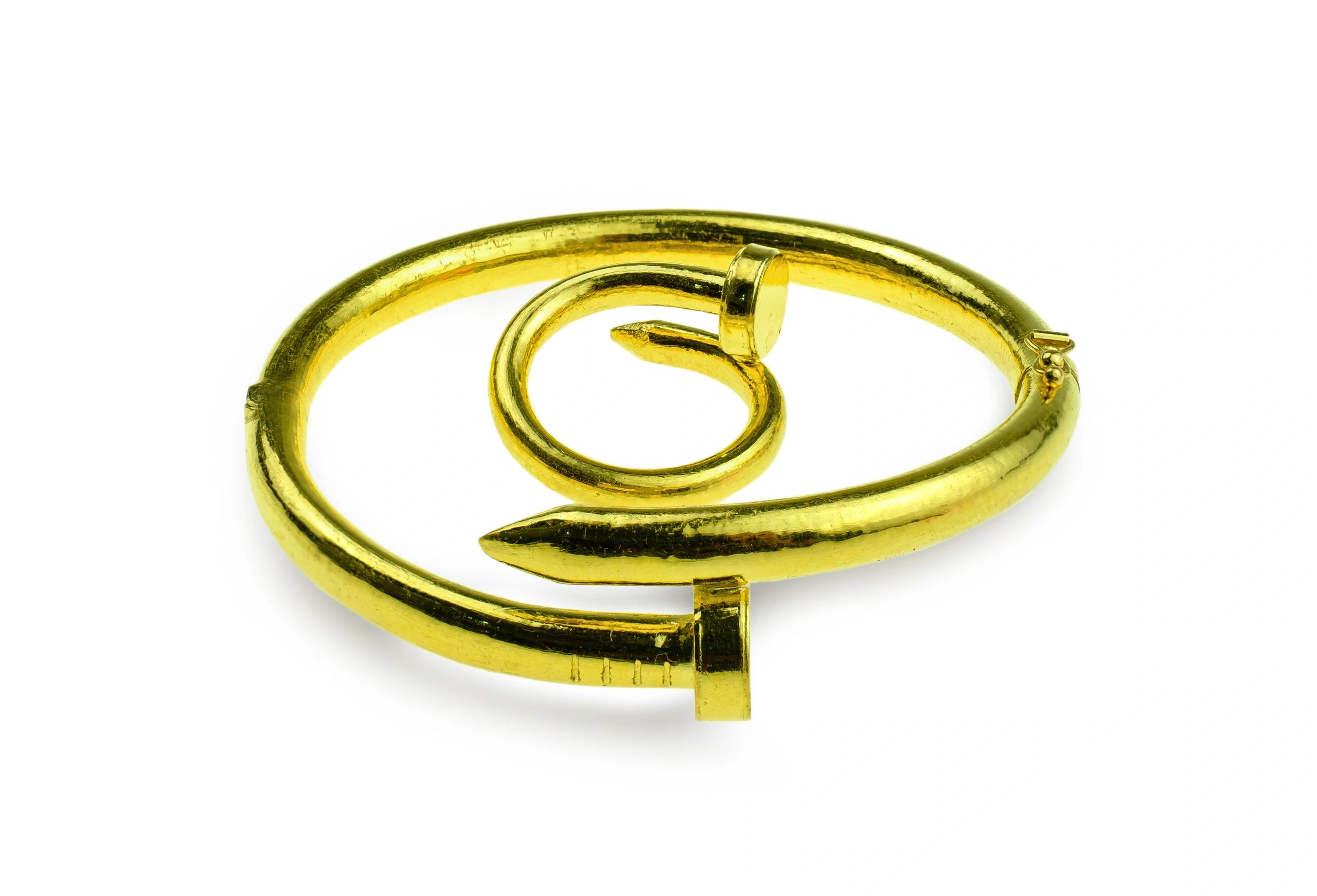 Gold bracelet and ring on a white background