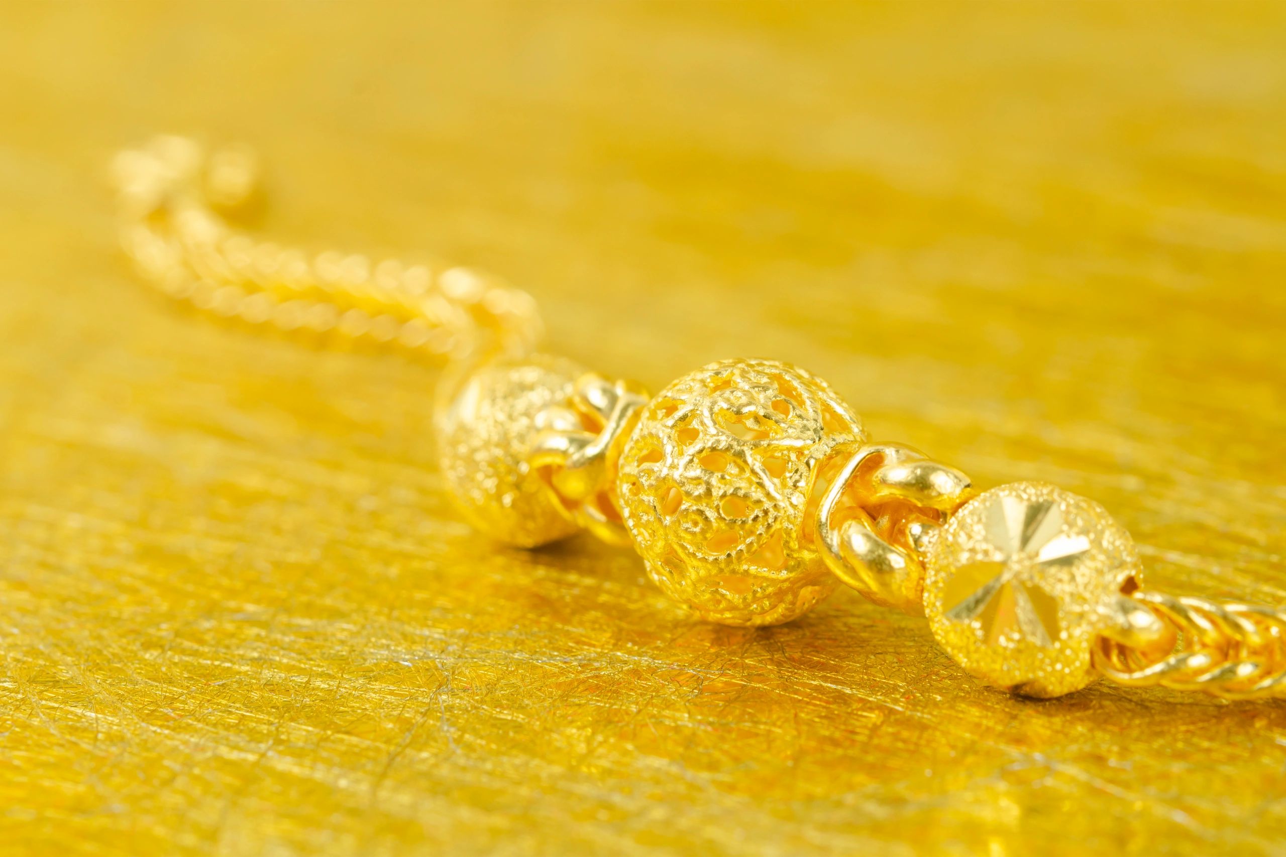 Gold bracelet on a premium gold background